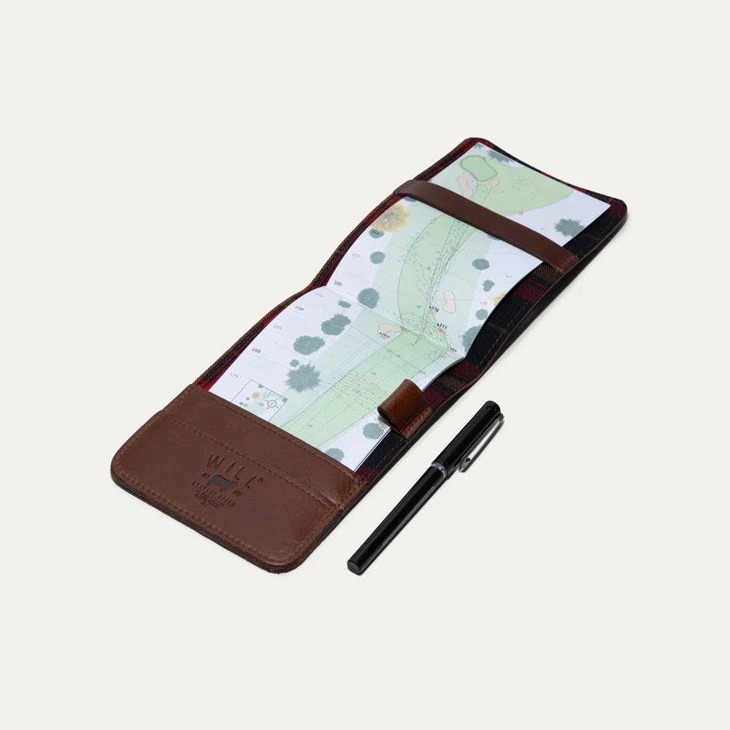 The WILL LEATHER GOODS GOLF YARDAGE BOOK IN COGNAC, by WILL LEATHER GOODS, features full-grain brown leather and a minimalist design—ideal for holding cards or a golf scorecard. It is shown closed on a plain white background.