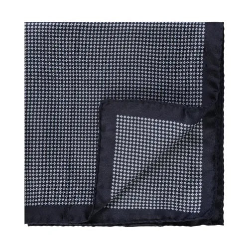 A navy silk pocket square by Amanda Christensen, featuring a refined micro pattern twill design and crafted with meticulous detail, is displayed with one corner elegantly folded over—an elevated choice in men’s accessories.