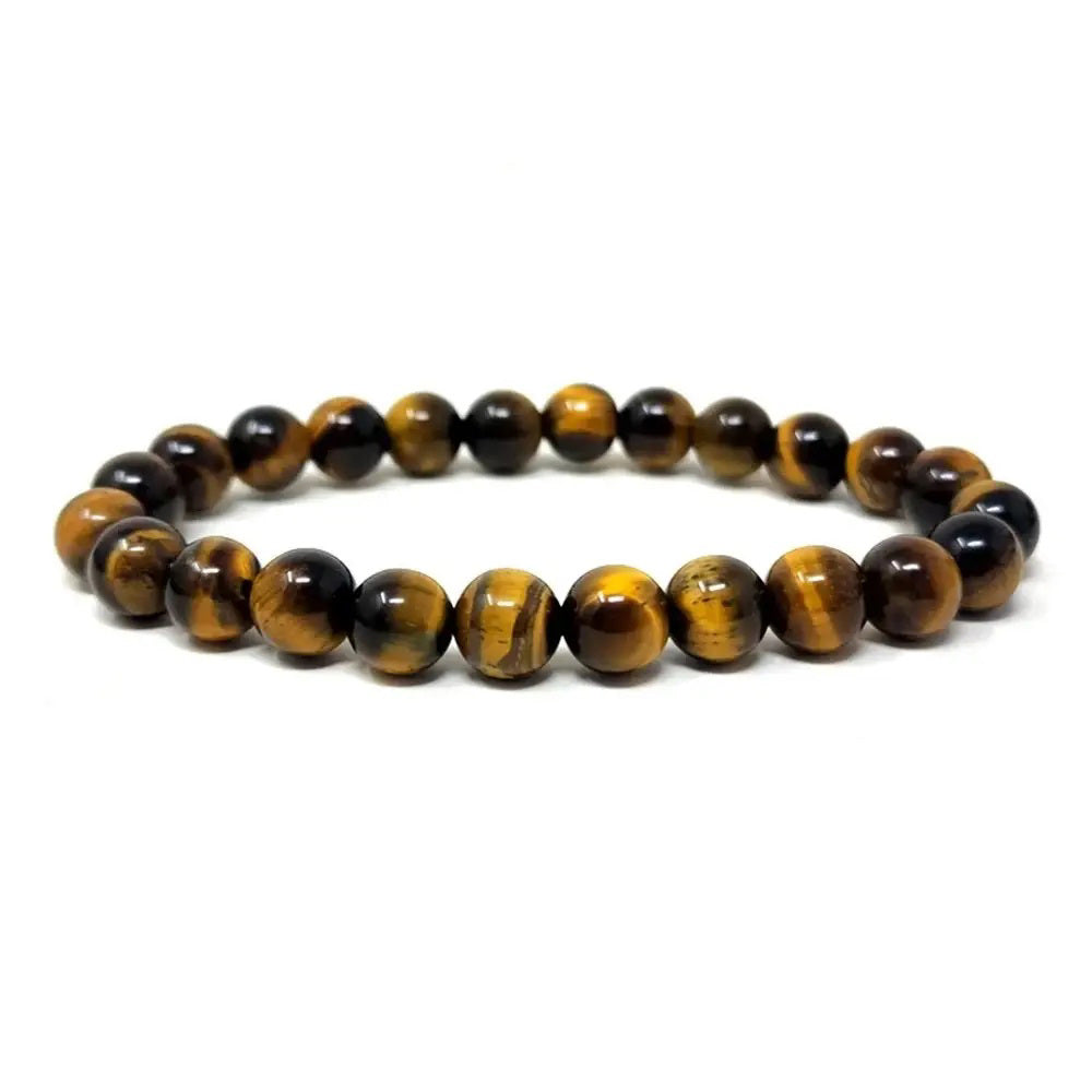 The STOLEN RICHES - MALLORCA TIGER EYE STONE BRACELET features polished round stones in brown and gold, arranged in a circular design to showcase grounding energy.