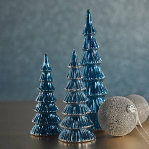 The ZODAX VERBIER LED TREE IN BLUE WITH SILVER TRIM is a small, blue glass Christmas tree figurine with tiered layers and an LED light, standing upright on a plain white background.