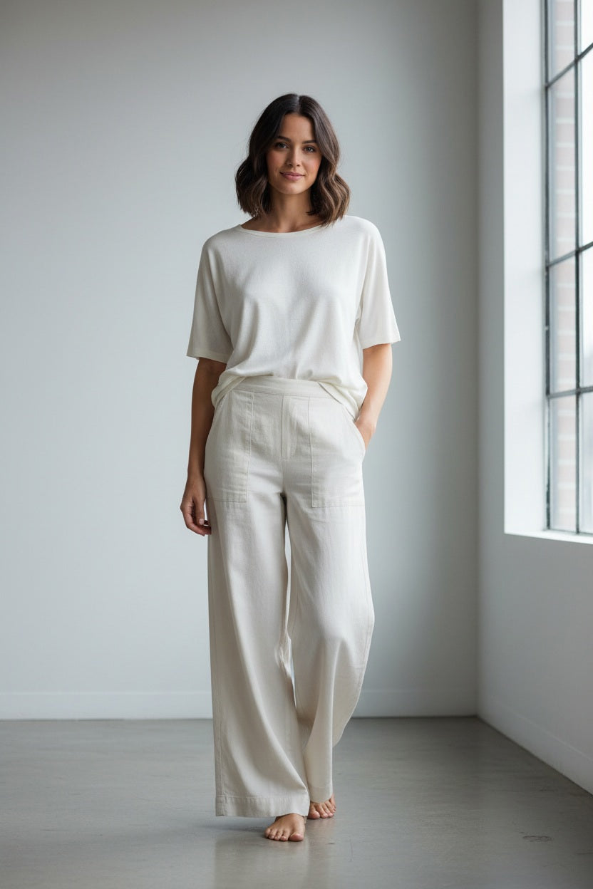 The FRANK &amp; EILEEN MADELINE Patch Pocket Pull On Pant in Famous Denim Vintage White features a wide-leg, high-waisted silhouette with front patch pockets and subtle stitch detailing. Crafted in California by FRANK &amp; EILEEN, these pants are shown laid flat on a white background.