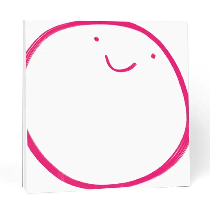 The E. FRANCES – CHUNKY NOTEPAD BIG SMILE by E. FRANCES PAPER features a playful pink smiley face on a white 6x6 notepad with thick chipboard backing.