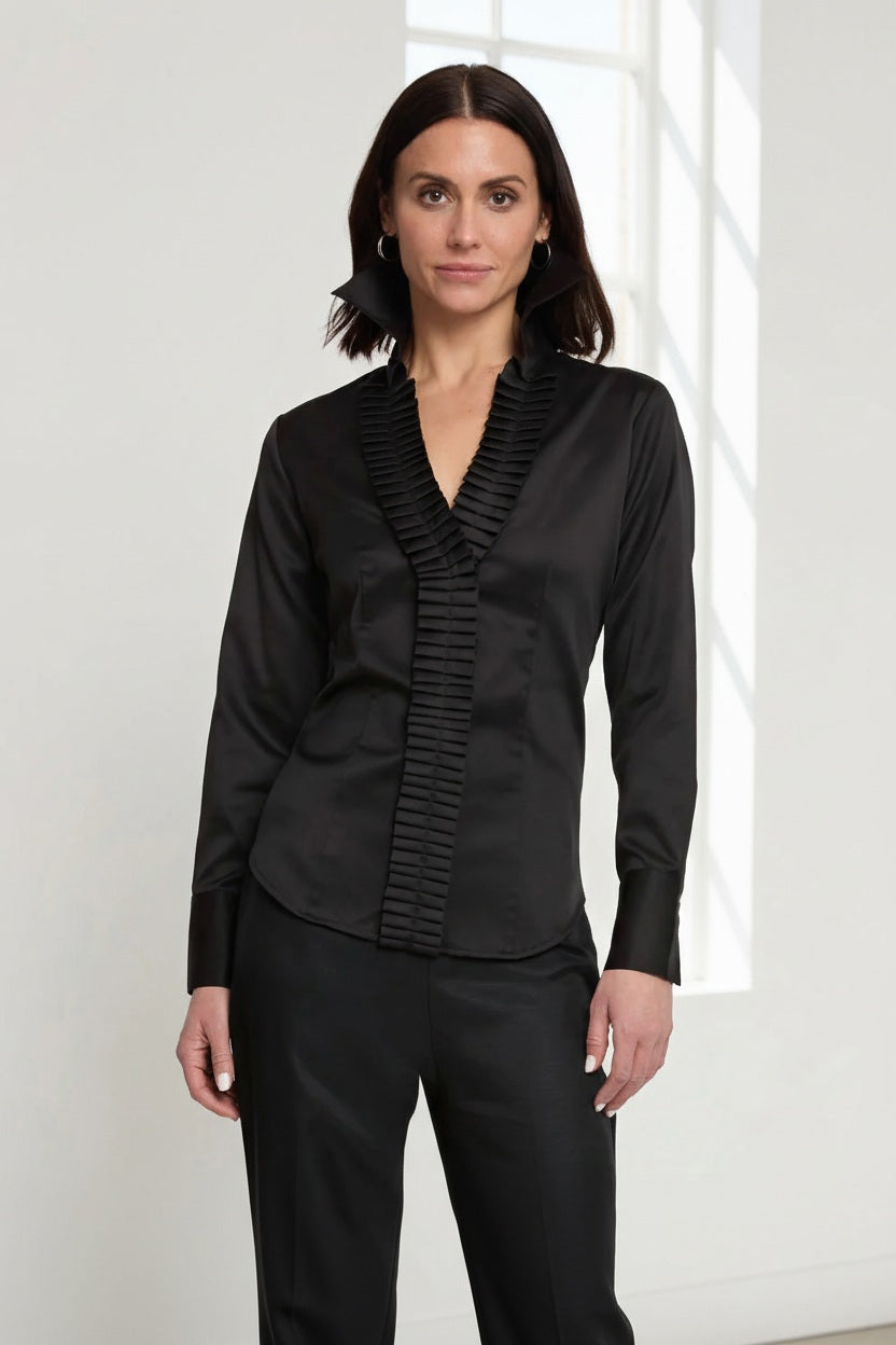 A woman with shoulder-length brown hair wears the HINSON WU Maya Long Sleeve Cotton Satin Shirt in white with pleated detailing on the collar and button placket, standing against a plain light background and looking at the camera.