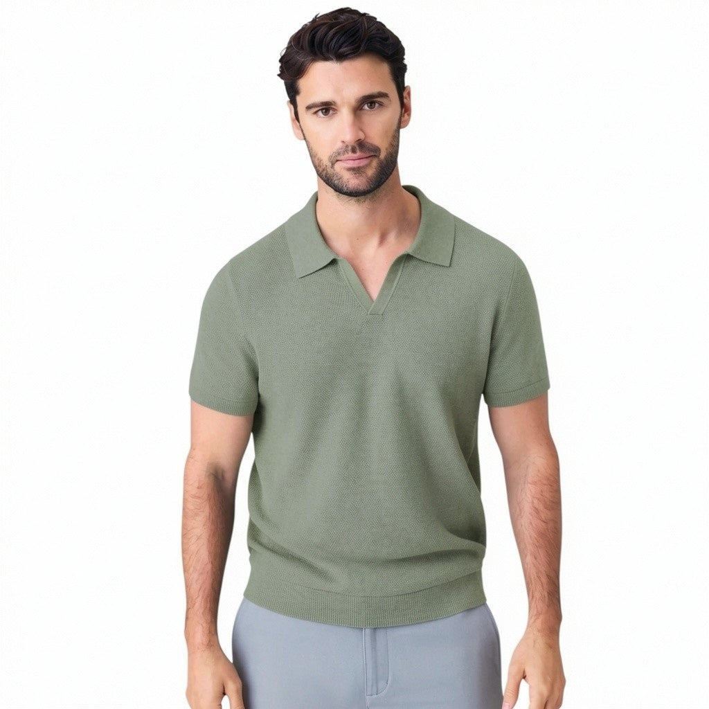 A man with short dark hair is seen from behind wearing the MACK WELDON Tech Linen Johnny Collar Polo Sweater in Sage Leaf Heather, paired with light gray pants against a plain light gray background.
