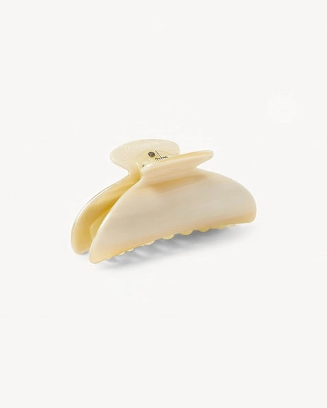 The MACHETE - MIDI HEIRLOOM CLAW by MACHETE is a pink and orange marbled hair claw clip, expertly crafted from premium Italian acetate. It features a curved design, wide grip, and interlocking teeth for a secure hold—ideal for medium volume hair. Shown against a plain white background.