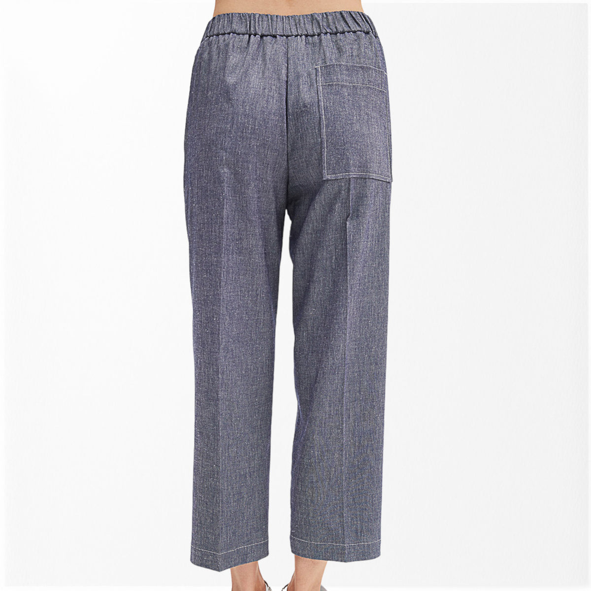 A person wearing the MEIMEIJ - DENIM COTTON PULL ON PANT in high-waisted, blue-gray denim with an elastic waistband, pocket detail, and relaxed, cropped legs stands against a plain white background. Only the pants and lower torso are visible.