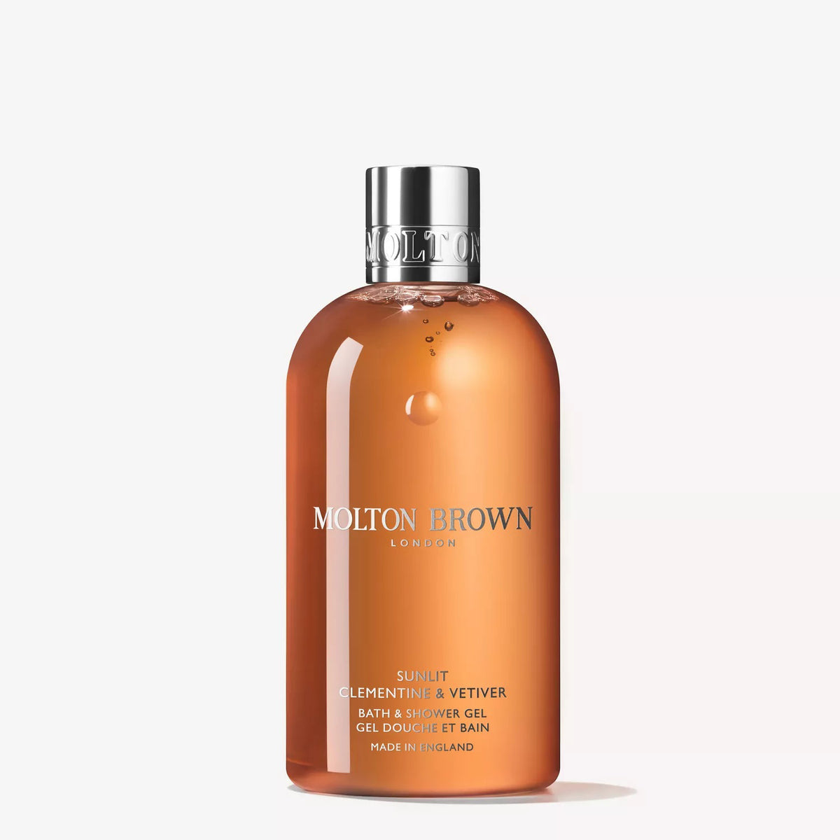 A bottle of MOLTON BROWN - SUNLIT CLEMENTINE &amp; VETIVER BODY WASH with vibrant orange liquid and a silver cap stands upright on a white background—a luxurious citrus body wash by MOLTON BROWN.