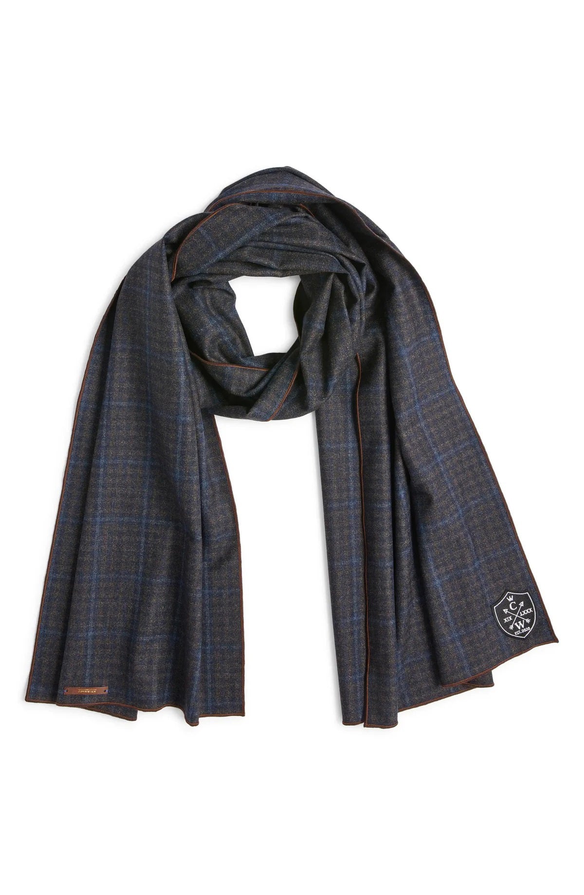 The CLIFTON WILSON Dark Gray and Blue Plaid Wool Scarf features premium wool with subtle check patterns and a small embroidered badge on one end, shown on a white background.