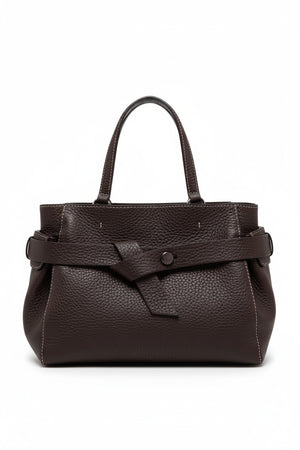 The GIANNI CHIARINI - MIRANDA HANDBAG IN ESPRESSO is a dark brown handbag crafted from pebbled, hammered leather, featuring two handles and a distinctive knotted strap detail across the front. It comes finished with a removable shoulder strap and is shown against a white background.