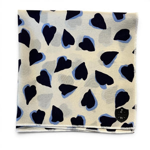 The CLIFTON WILSON Navy and White Hearts Silk Pocket Square features irregular navy and black heart motifs with light blue outlines—a unique, stylish accessory ideal for weddings or special occasions.
