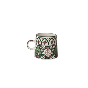 The CREATIVE COOP HAND-PAINTED STONEWARE MUG showcases a green and brown floral pattern with geometric and leaf motifs encircling its slightly flared body. This rustic mug features a comfortable handle and beautifully detailed decorative art, all carefully hand-painted on durable stoneware.