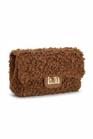 The VICARIO CINQUE Brescia Bag in brown by VICARIO CINQUE showcases a soft, curly bouclé texture with a modern rectangular gold clasp on the front, embodying Italian-inspired chic style and contemporary elegance.