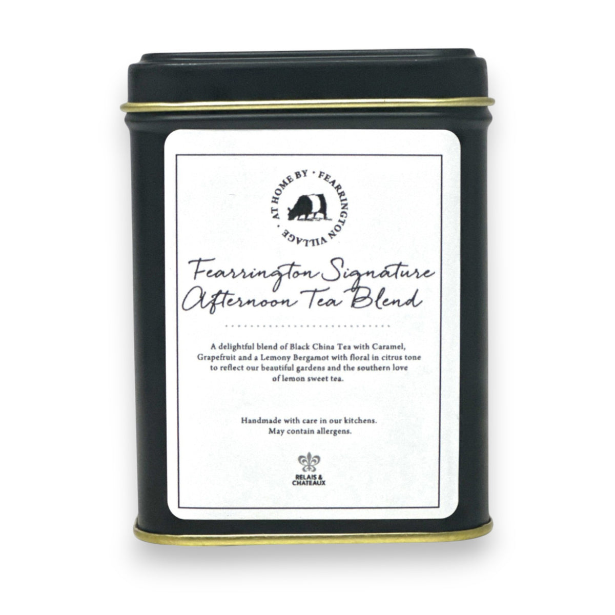 A black tin labeled &quot;Fearrington Signature Afternoon Tea Tin&quot; from the Fearrington House Signature Collection contains a luxurious blend of Loose Leaf Black China Tea with caramel, grapefruit, and lavender. The tin has a simple, elegant design accented by a white label featuring the product description.