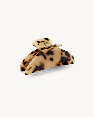 The MACHETE - MIDI HEIRLOOM CLAW by MACHETE is featured against a plain white background. This cream-colored hair accessory is crafted from luxurious Italian acetate and features curved edges with interlocking teeth, making it ideal for securing medium hair with effortless style.