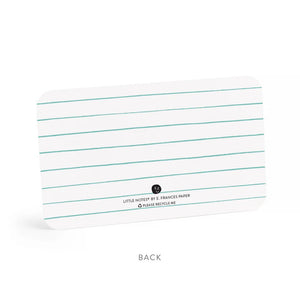 A clear plastic box contains E. Frances Paper - Thanks Little Notes, each decorated with "THANKS!" on the cover. These charming cards showcase a subtle watercolor design, encouraging generous use for any occasion.