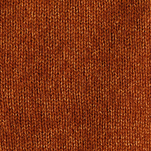 Close-up of a warm, rusty orange knitted fabric showcasing the even stockinette stitch texture of the BASE MILANO - BOXY OVERSIZED V NECK SWEATER by BASE MILANO.