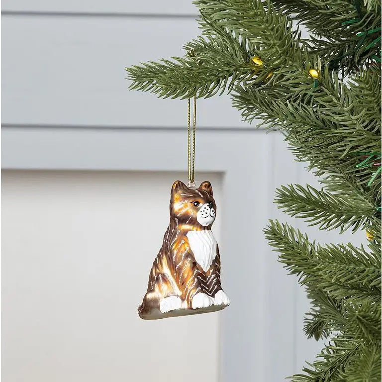 TABBY CAT ORNAMENT made of glass featuring brown tabby stripes, a white chest, and white paws.