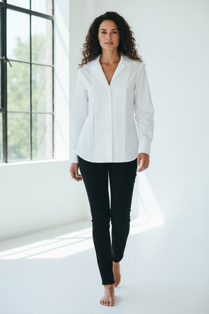 A woman with blonde hair tied back is wearing the HINSON WU DONNA 3/4 SLEEVE TOP and black pants, standing against a plain light background and looking at the camera.