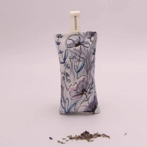 A L'AUGUSTE PROVENCE French Lavender Sachet from Provence is displayed in front of a bundle of dried lavender on a white surface.