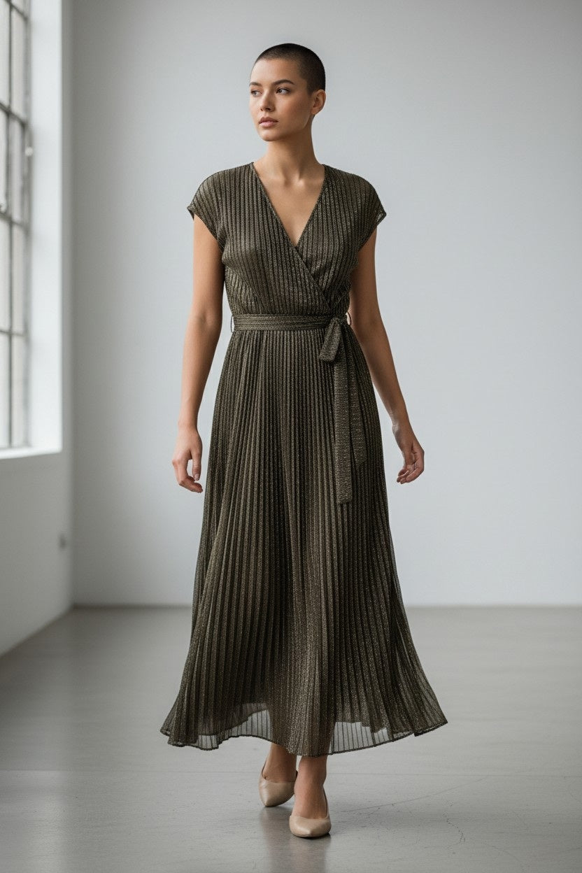 The SANDRO FERRONE - CROSSOVER V NECK DRESS is sleeveless, ankle-length, with metallic pleats, a belted waist, and a V-neckline, shown on a plain light gray background.