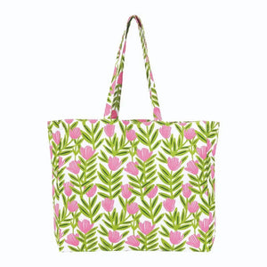 The ROCKFLOWERPAPER Pink Delight Little Shopper Tote Bag features fashion prints of green leaves and pink flowers with matching handles on cotton canvas. Perfect as a grab-and-go accessory for everyday style.