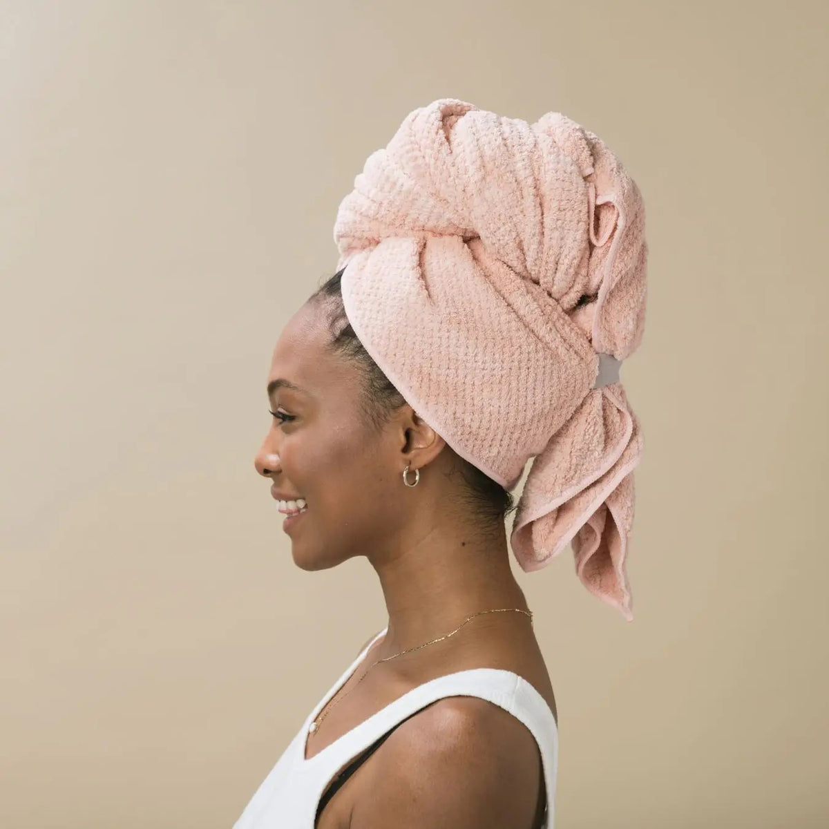 A packaged VOLO BEAUTY HAIR HERO TOWEL with soft Nanoweave fabric is in a clear bag, showing two Best of Beauty awards on the top right, set against a beige background.