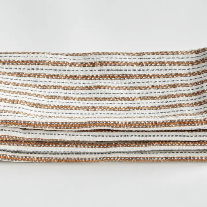 Elevate your table linens collection with the NAPA HOME AND GARDEN - SUTTON DINNER NAPKIN. This folded cotton napkin, featuring brown, white, and gray vertical stripes accented by decorative brown stitching along the edges, offers a stylish soft ochre touch—perfect for bringing both elegance and versatility to any dining setting. Displayed against a crisp white background, it’s a standout piece from NAPA HOME AND GARDEN.