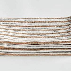 Elevate your table linens collection with the NAPA HOME AND GARDEN - SUTTON DINNER NAPKIN. This folded cotton napkin, featuring brown, white, and gray vertical stripes accented by decorative brown stitching along the edges, offers a stylish soft ochre touch—perfect for bringing both elegance and versatility to any dining setting. Displayed against a crisp white background, it’s a standout piece from NAPA HOME AND GARDEN.