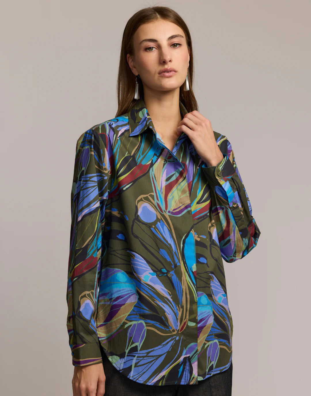 A woman with long brown hair wears the HINSON WU Halsey Long Sleeve Shirt in Abstract Print, made from a premium cotton blend, posing against a plain background with a neutral expression.