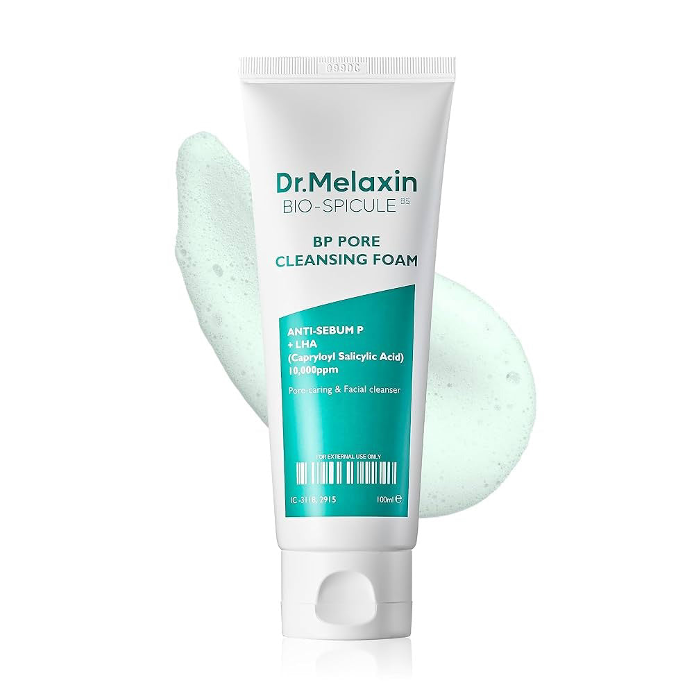 A white tube of DR MELAXIN - BP PORE CLEANSING FOAM by KOSMIC KBEAUTY SKINCARE stands upright with a light blue foam smear. This anti-sebum formula with salicylic acid targets sebum control and is ideal for acne-prone skin.
