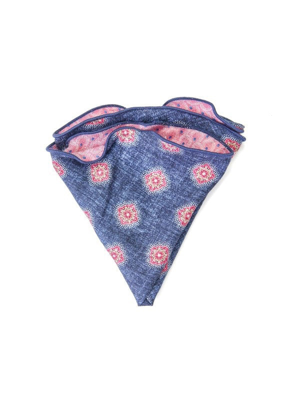 The EDWARD ARMAH Silk Reversible Pocket Circle Denim Foulard features a pink side with blue and red dots, a blue side with red and white geometric designs, and dark blue trimmed edges.
