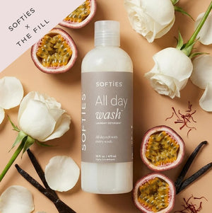A bottle of SOFTIES - ALL DAY WASH™ LAUNDRY DETERGENT on a white textured surface.