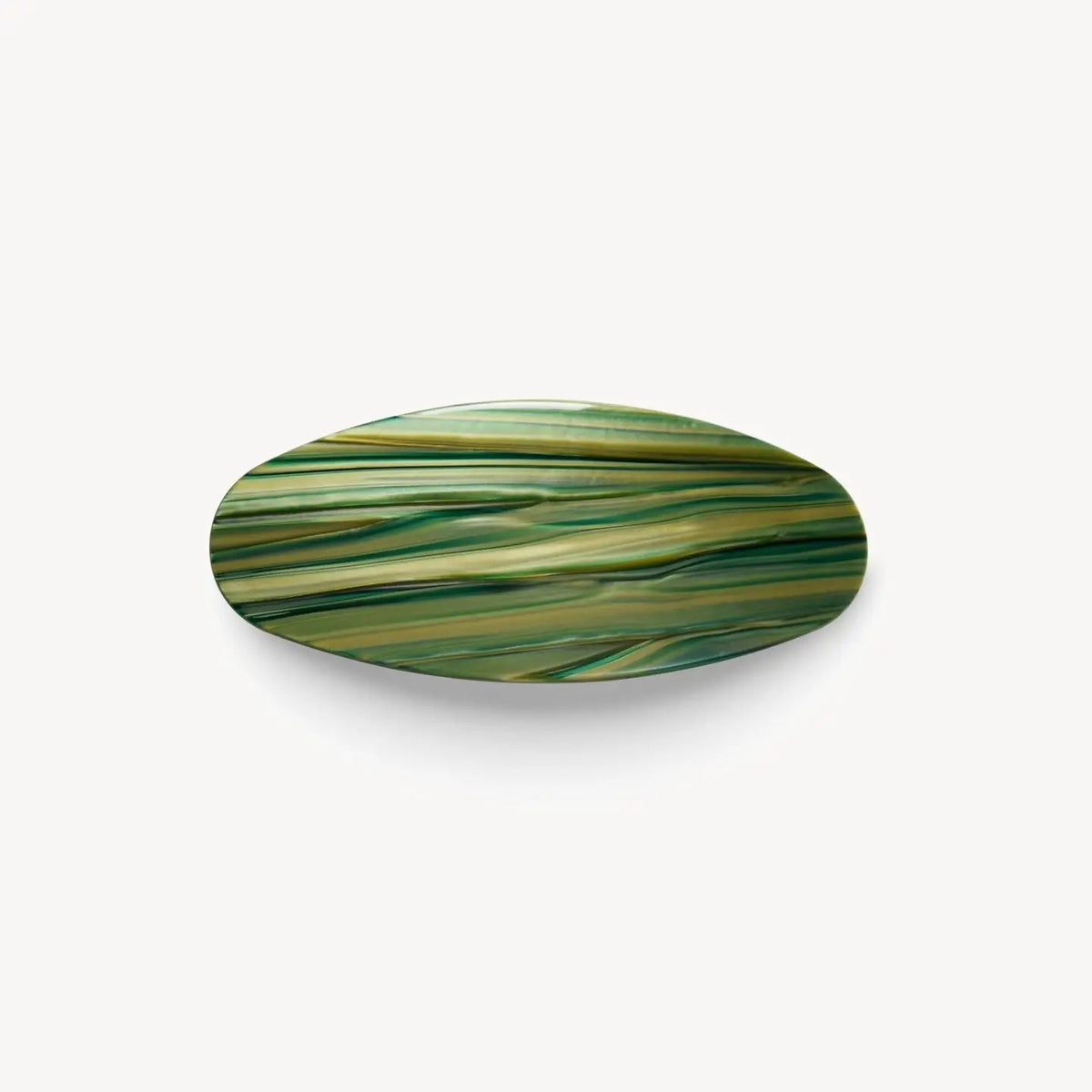 The MACHETE - Jumbo Oval Barrette in Meadow features a glossy, oversized Italian acetate design with a marbled green and yellow pattern, shown against a plain white background.