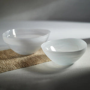 The ZODAX MONTE CARLO ALABASTER GLASS BOWL is a glossy, white, asymmetrical glass bowl measuring 9.75 in x 4.25 in, shown on a white background.