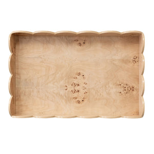 A CREATIVE COOP BURL WOOD VENEER FOLDING TABLE with a removable scalloped tray displays bottles, glasses, and blue-and-white vases with branches on top; the lower shelf holds books, more bottles, and a small bowl. It rests on a light wood floor.