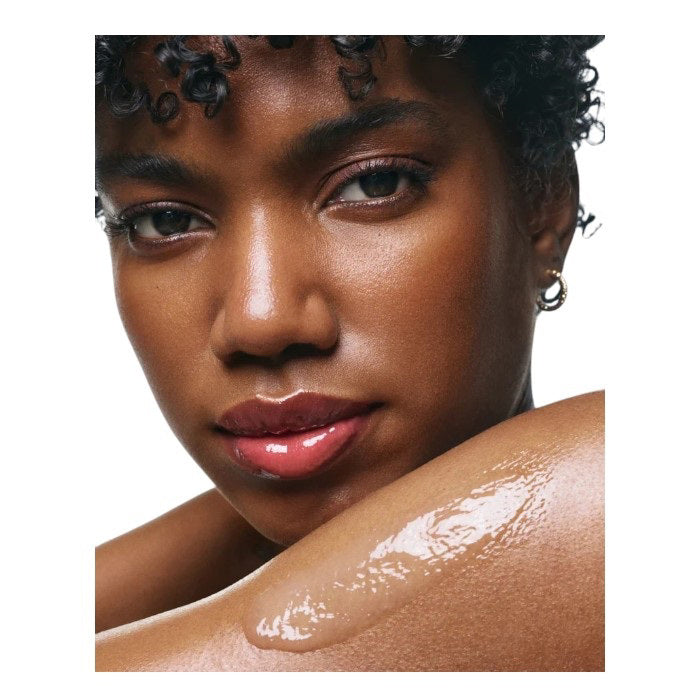 A tall, white bottle with a minimalist design and black text displays &quot;U BEAUTY RESURFACING BODY COMPOUND 200ML.&quot; This body exfoliant is formulated to improve skin texture for a smoother look.