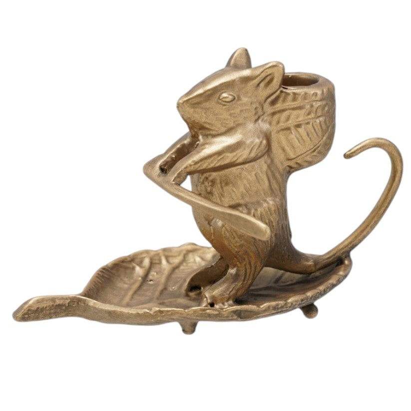 The CREATIVE COOP MOUSE ON LEAF CAST METAL TAPER HOLDER features an antique gold finish, measures 6"L x 3.25"H, and has a curled tail while sitting on a leaf-shaped base. Shown on a white background.