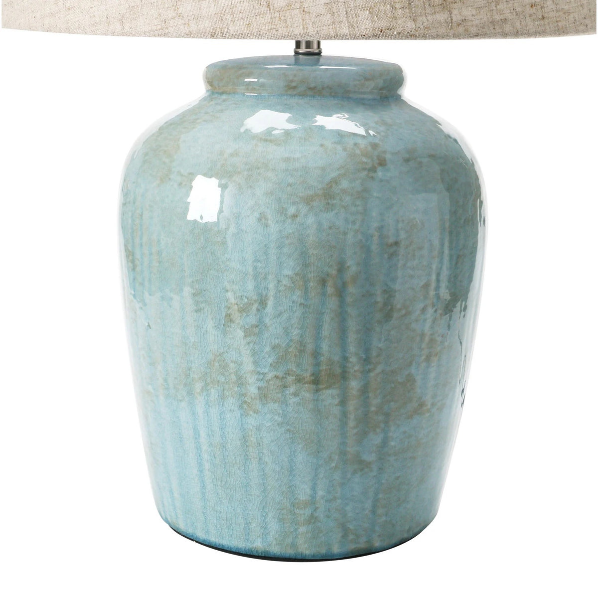 The CREATIVE COOP AQUA STONEWARE LAMP WITH LINEN SHADE features a nature-inspired design with a muted green textured ceramic base and a beige linen shade, set against a white background.