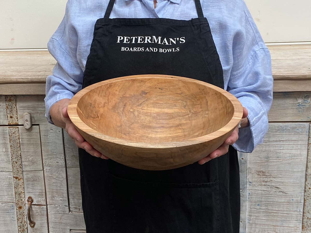 A handcrafted SPENCER PETERMAN - SPALTED MAPLE BOWL 13" by PETERMANS BOARDS & BOWLS INC, featuring a round shape with a light, natural finish and striking spalted maple grain patterns, displayed on a white background.