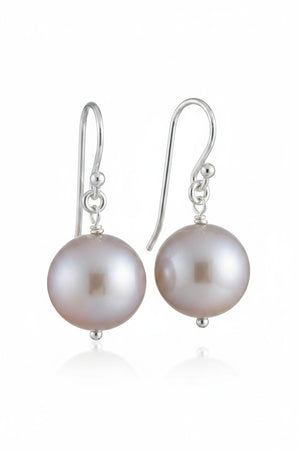 ANN LIGHTFOOT FRESHWATER PEARL DROP EARRINGS feature a single round white freshwater pearl on sterling silver earwires, shown hanging from a dark rod against a white background.