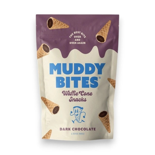 A chocolate-filled waffle cone, MUDDY BITES- DARK CHOCOLATE WAFFLE CONES, is centered against a purple background. Text reads "Creamy Dark Chocolate: Premium delicious dark chocolate made from simple ingredients" with an arrow pointing to the chocolate and "Crunchy Cone: Light crisp cone that blends perfectly with our creamy dark chocolate" with an arrow pointing to the cone. Logos for "GMO Free" and Kosher certification are at
