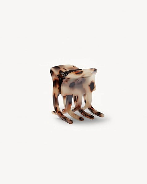 The MACHETE - MINI CLAW by MACHETE is an Italian acetate hair clip in a brown and beige tortoiseshell pattern, featuring a rounded top and multiple curved gripping prongs, shown against a plain white background.