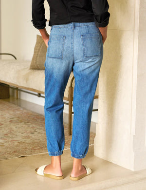 FRANK & EILEEN Jameson Utility Jogger Jean in 1968 Wash: light blue denim joggers with a mid-rise waistband, front patch pockets, and elastic cuffs at the ankles, shown flat on a white background.