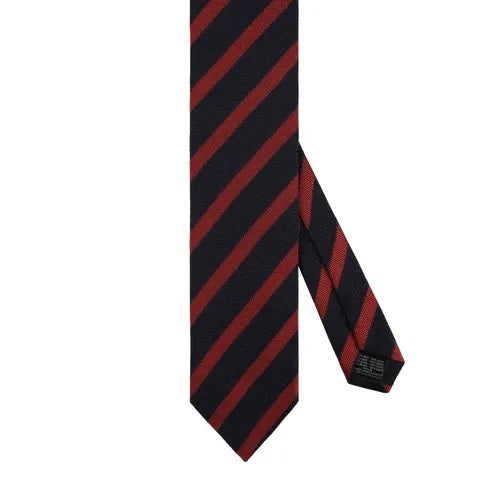 A close-up of the AMANDA CHRISTENSEN - STRIPED JACQUARD WOVEN SILK TIE IN RUST reveals its elegant red diagonal stripes on luxurious Italian silk, with a label bearing the AMANDA CHRISTENSEN name against a white background—an exceptional men’s formal accessory perfect for any refined occasion.