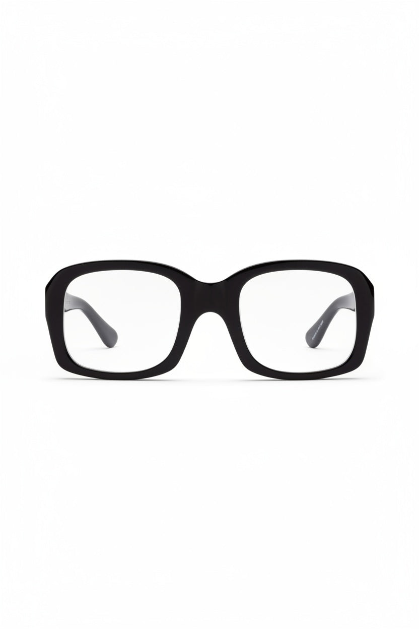 CADDIS - SHELBY PROGRESSIVE READERS by CADDIS are black, square, thick-rimmed eyeglasses with oversized frames and clear, scratch-resistant lenses. Shown front-facing on white; "Shelby" printed in white inside the left arm.