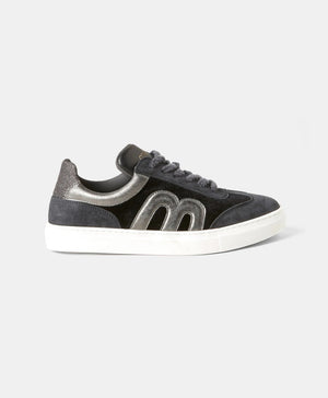The iconic Momonì - Venezia Sneakers by MOMONI, showcasing black leather uppers and gray laces, are positioned side by side, facing forward. They feature white box soles and a logo on the tongue area. The background is a plain white surface.