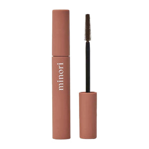 Three close-up shots of a blue eye: lashes with no mascara (before), lashes enhanced with MINORI - MOTHER OF LASHES MASCARA, BROWN by MINORI, and lashes with black mascara, highlighting the color and definition differences.