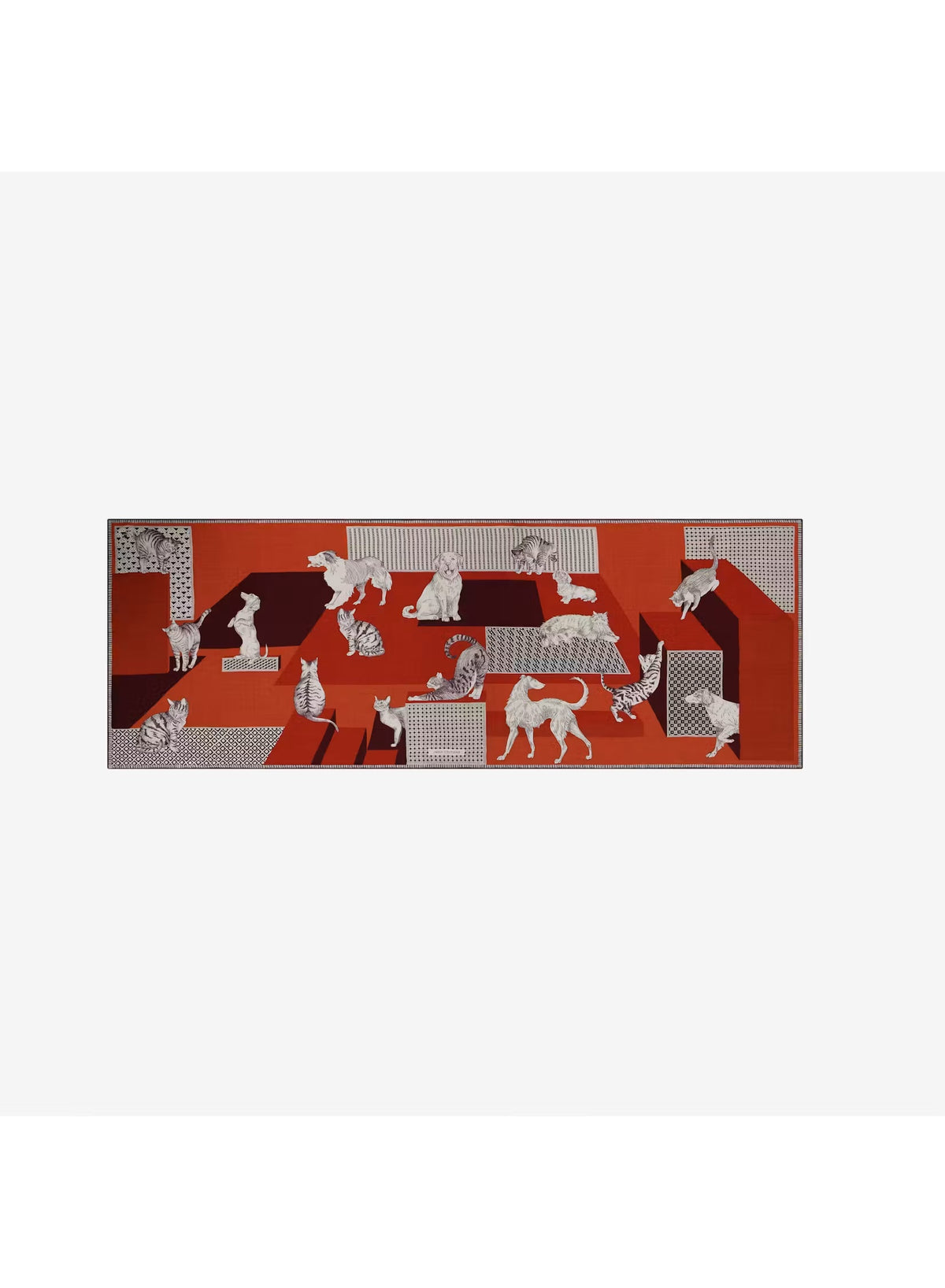 A person dressed in a cream outfit models the INOUI EDITIONS - LES CHERIS WOOL SCARF IN RED by INOUI—a 100% wool accessory made in India, featuring bold orange, red, and burgundy tones adorned with large white cat illustrations and geometric patterns—set against a plain background.