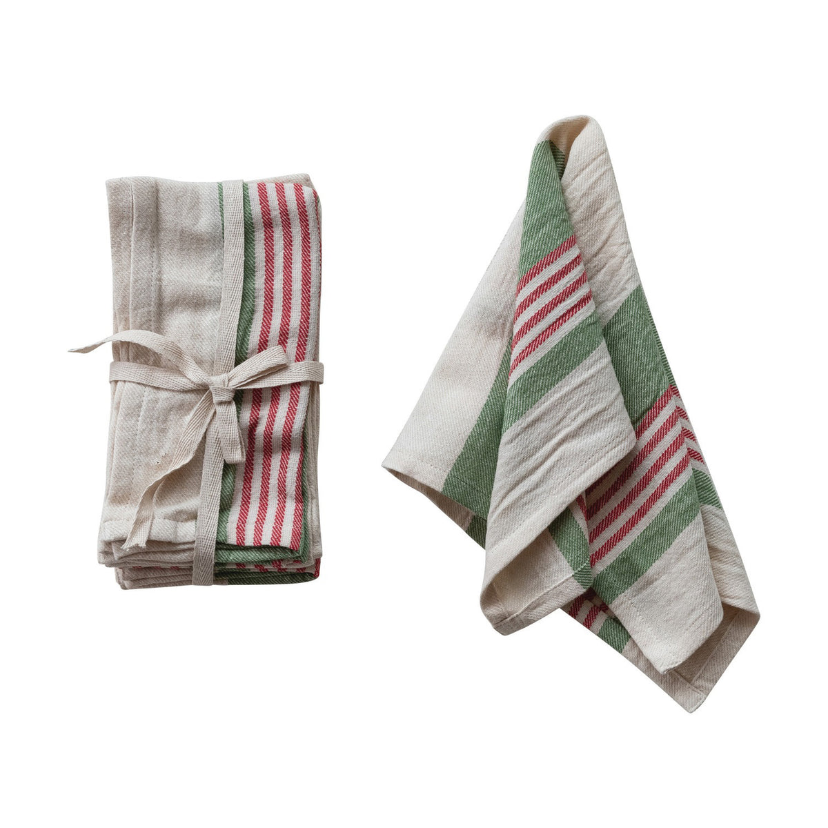 The CREATIVE COOP GREEN AND RED STRIPE COTTON NAPKIN set includes two napkins with bold stripes on a cream background—one folded with a cloth ribbon, the other unfolded and draped to show off its charming design.