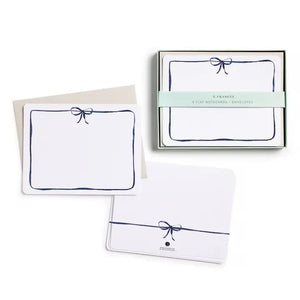 E. FRANCES PAPER's Flat Notes Navy Bow set includes illustrated notecards with matching envelopes, each featuring a blue border and navy bow. Partially boxed with a green band label—ideal for handwritten notes.